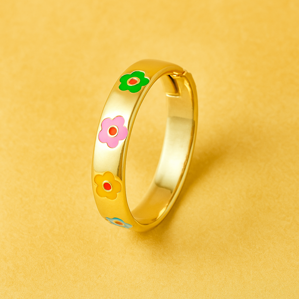 Gold ring with colorful flower designs on a yellow background