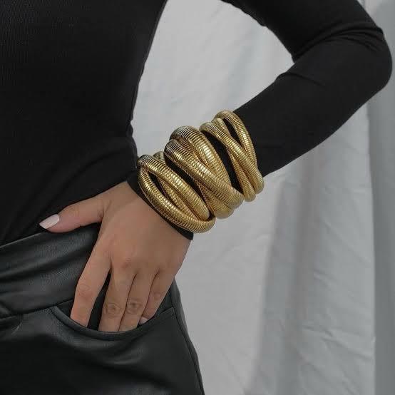 18k gold plated anti tarnish coiled overlapped bracelet showcased on the hand of model