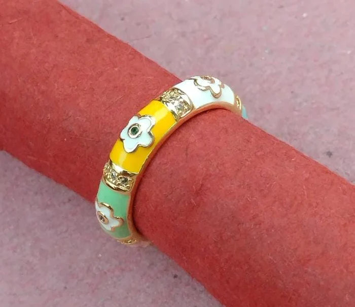 Decorative ring with floral designs on a pink surface