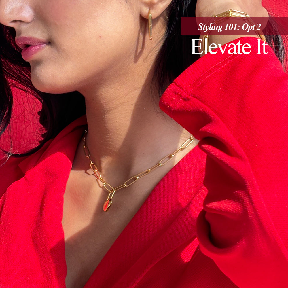 A gold-plated link chain necklace displayed on a different styling