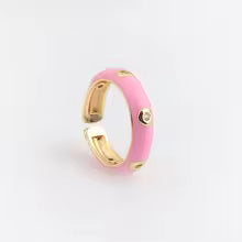 Pink ring with gold accents on a white background