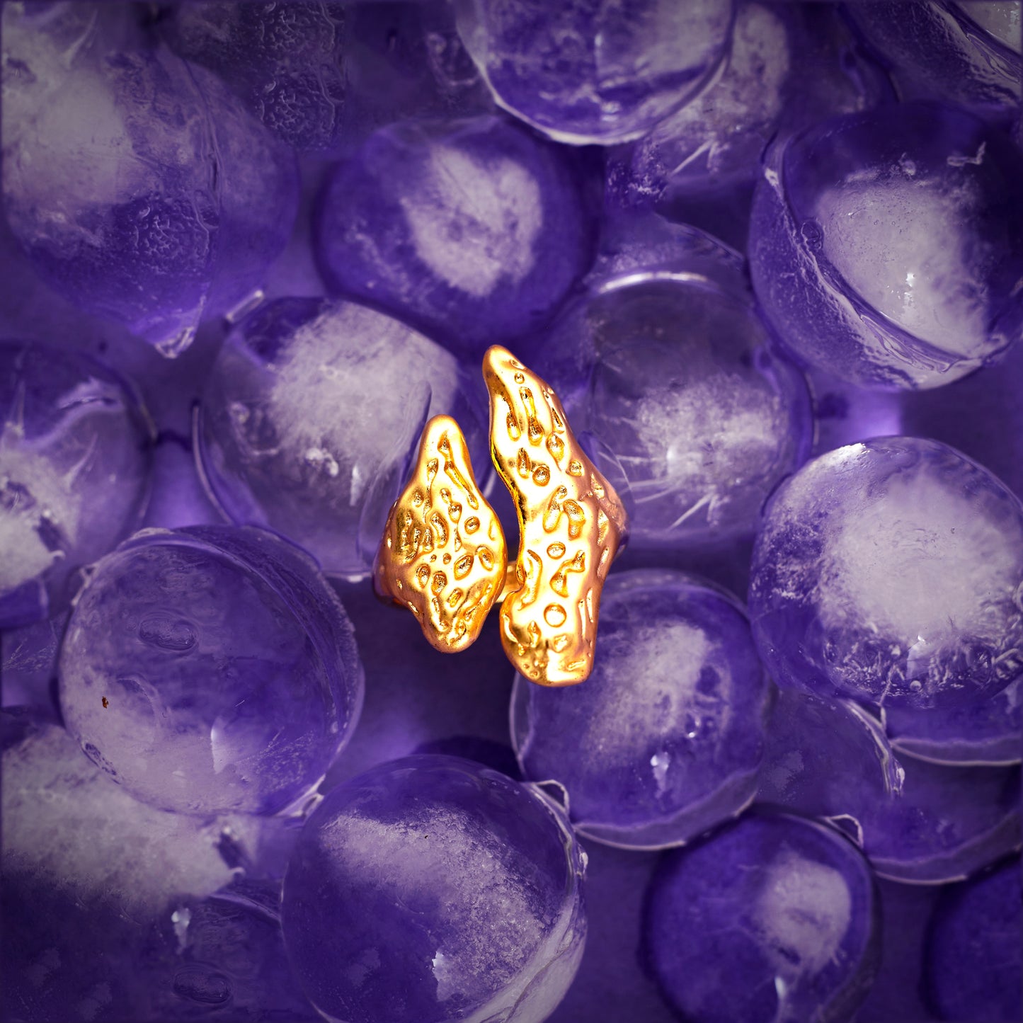 18k gold plated ring with texture on it showcased on purple background ice