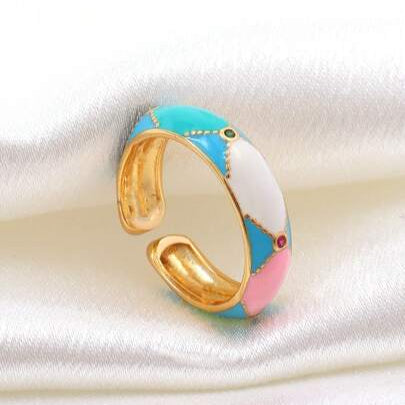 gold anti tarnish ring with colorful enamel design on it with stones embedded 
