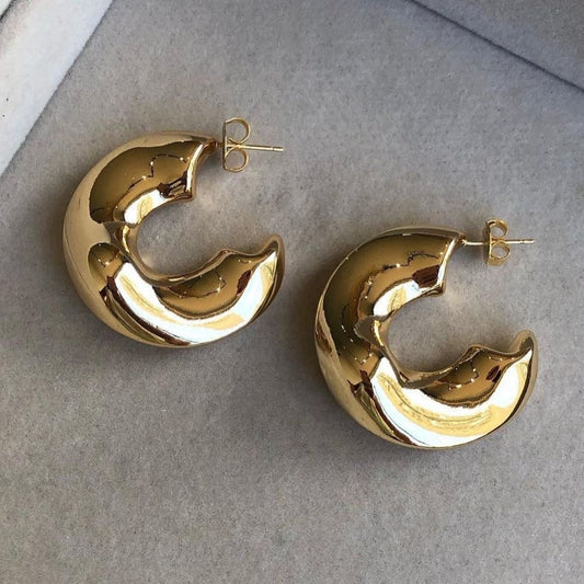 gold hoops with one side open presented on its side 