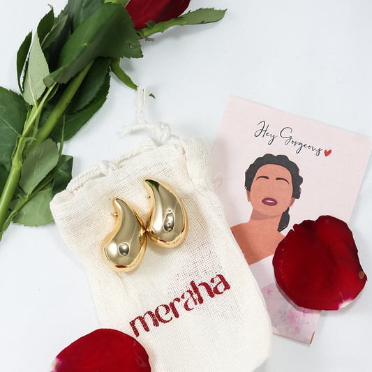 18k gold plated drop shaped earring placed on meraha display