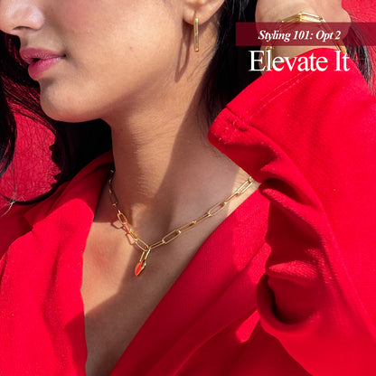 A gold-plated link chain necklace displayed on a different styling
