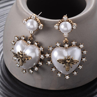 Pearl heart drop earrings with gold bee charm